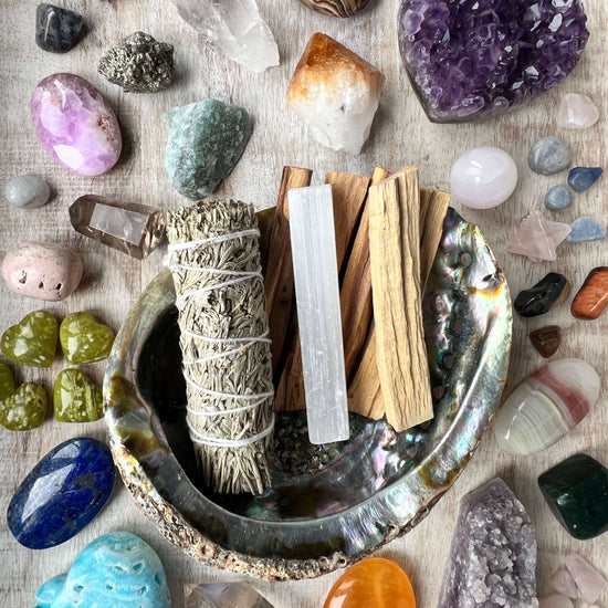 White-Sage-Palo-Santo-Selenite-in-a-bowl-surrounded-by-crystals