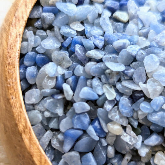 Close-up of blue aventurine chips in a wooden bowl