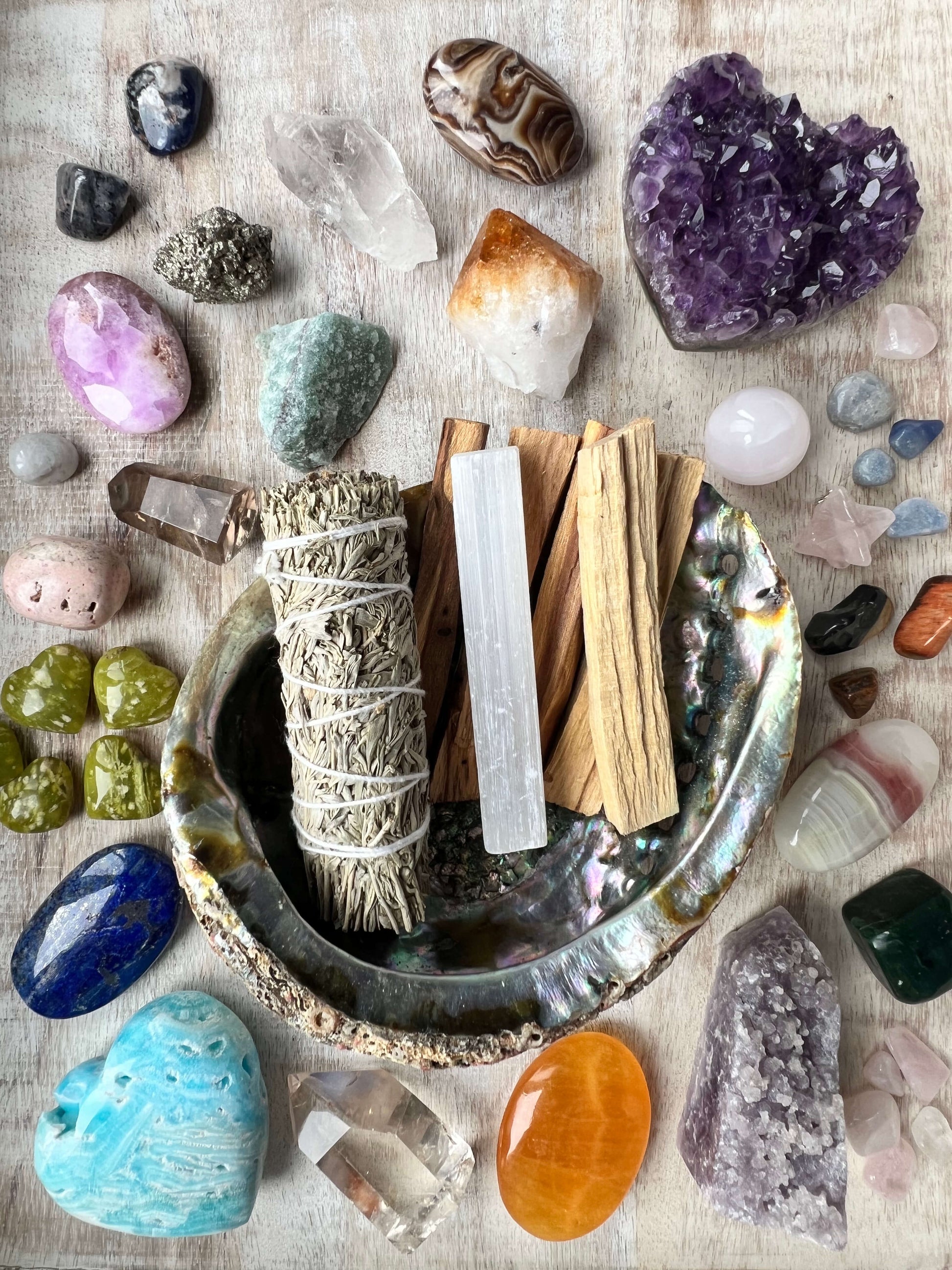 White-Sage-Palo-Santo-Selenite-in-a-bowl-surrounded-by-crystals