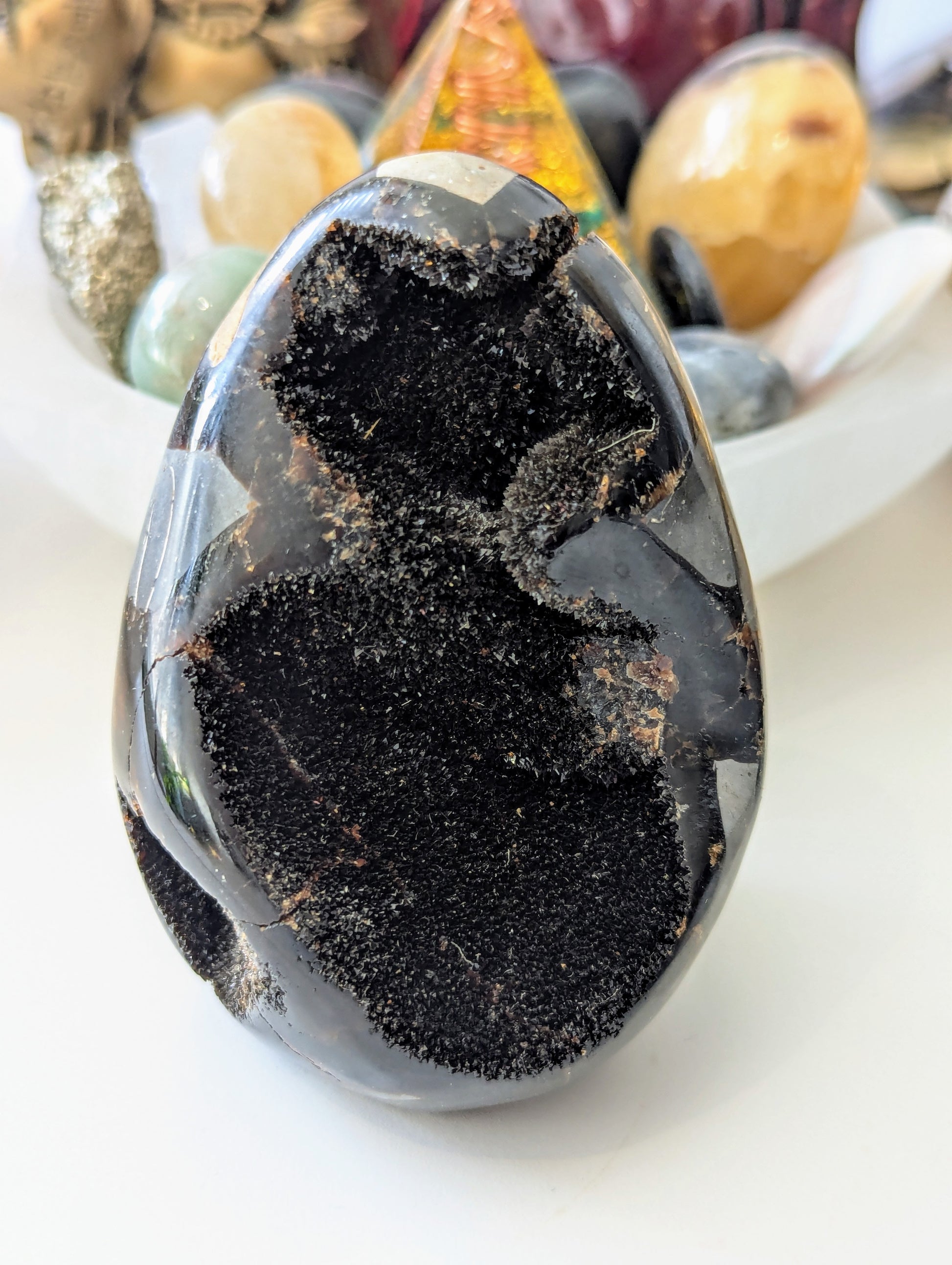 Dragon crystal egg on a white surface with blurred background