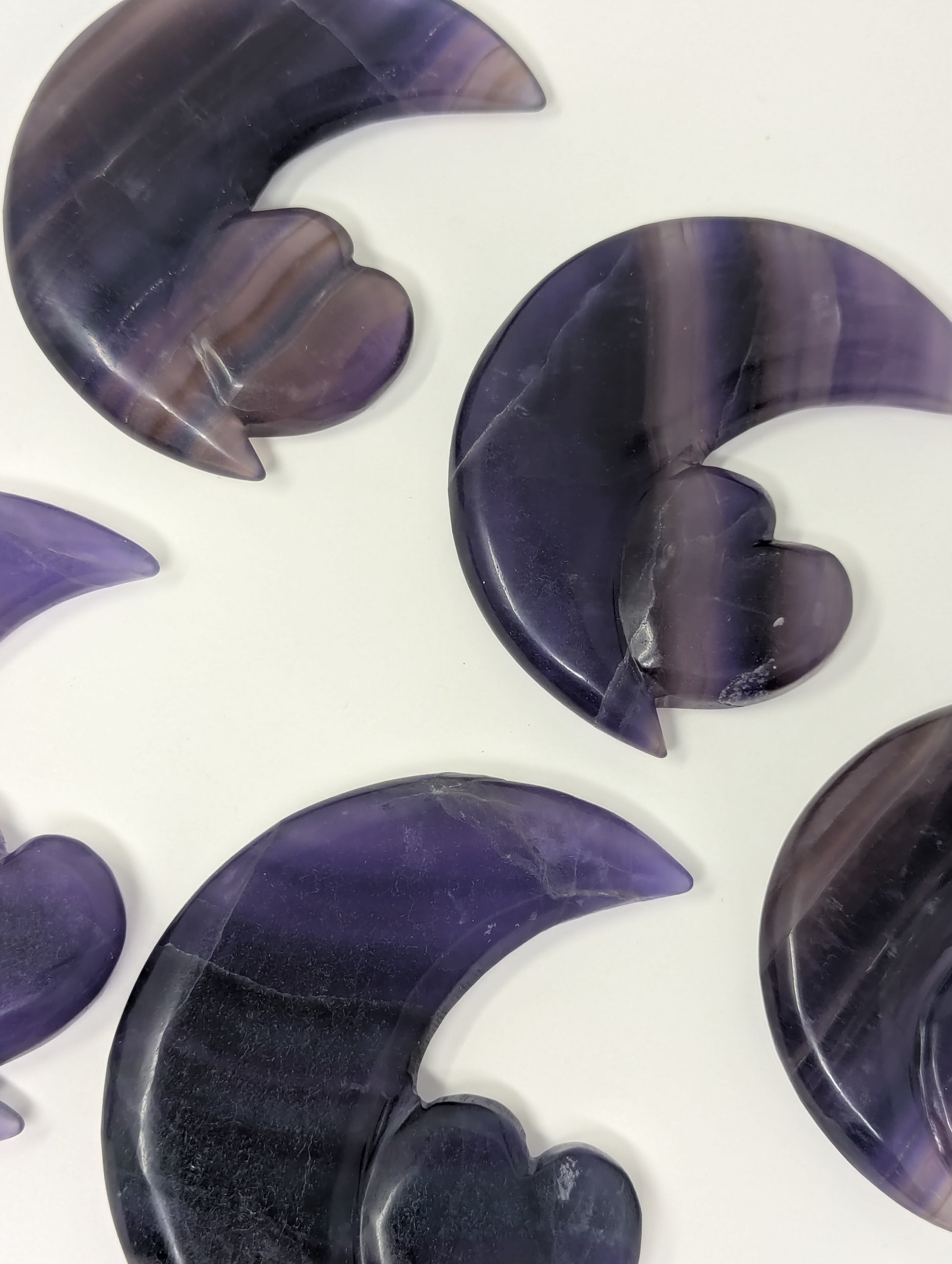 Purple stone crescent moon shapes on a white background